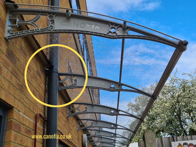 How to install a canopy on a wall that has a down pipe?