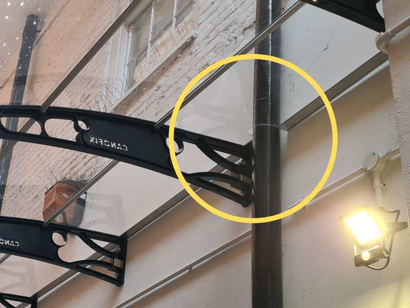 How to install a canopy on a wall that has a down pipe?